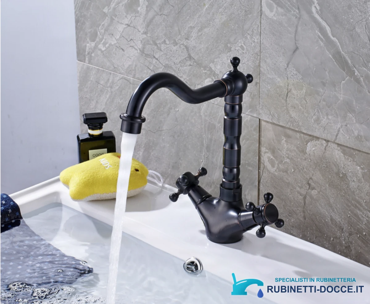 Rubinetto lavabo anticato ANT2309 con lavabo bianco e parete in pietra grigia